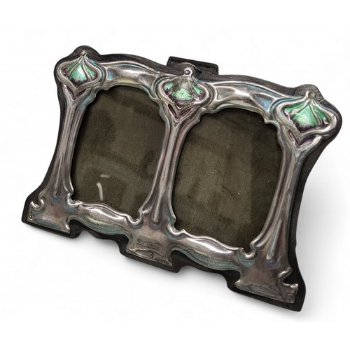 341 - An Art Nouveau style silver and enamel double easel photograph frame, embossed with sinuous scrolls,... 