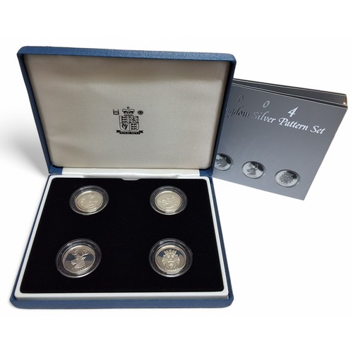 212 - A Royal Mint 2004 United Kingdom Silver Pattern Set, four 925 silver one pound pattern coins four En... 