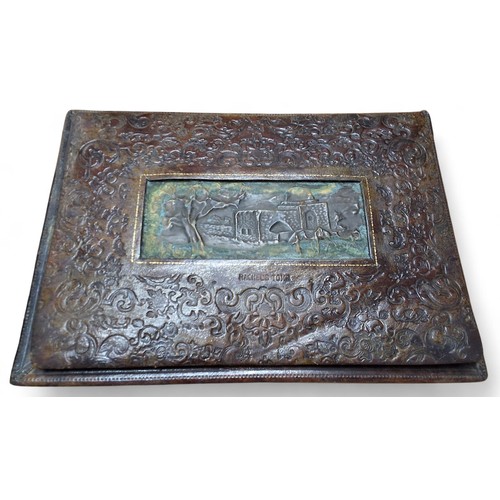 Militaria - a embossed leather desk blotter folder, centrally mounted ...
