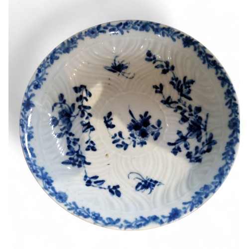 69 - A Worcester Feather Moulded Floral pattern tea bowl and saucer, painted in cobalt blue with trailing... 