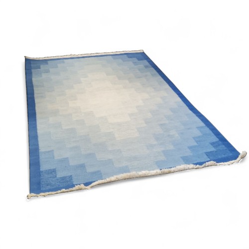 193 - A 20th century Swedish woollen rug, with a geometrical motif, in tones of blue and cream, 202 x 142c... 