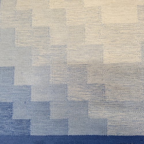 193 - A 20th century Swedish woollen rug, with a geometrical motif, in tones of blue and cream, 202 x 142c... 