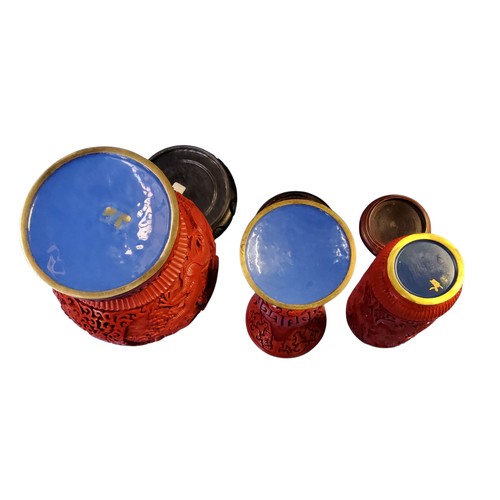 79 - A Chinese red cinnabar vase, typically in relief with scrolling dragon and peonies, hardwood stand, ... 