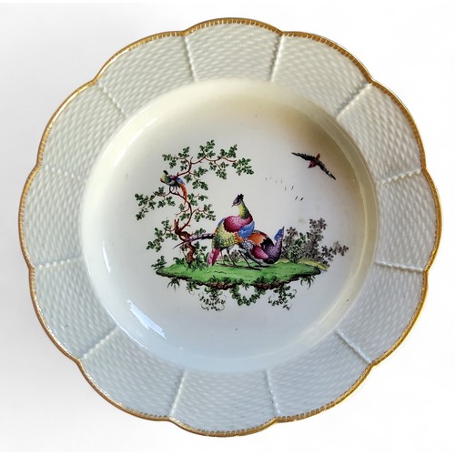 25 - A Worcester shaped circular plate, the field painted with fanciful birds and folaige, basketweave bo... 
