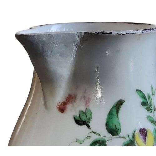 32 - A Bristol sparrow beak jug, decorated with a spray of colourful summer flowers, brown rim, 9.5cm hig... 