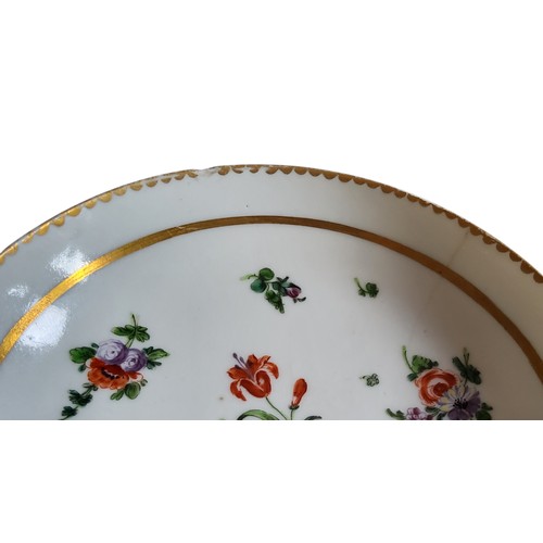 36 - A Bristol cup and saucer, decorated in polychrome with scatter sprays, gilt line border, dentil rim,... 