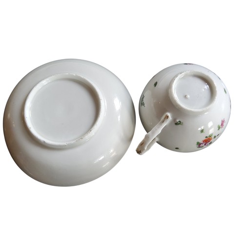 36 - A Bristol cup and saucer, decorated in polychrome with scatter sprays, gilt line border, dentil rim,... 