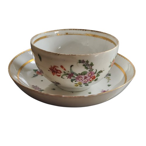 36 - A Bristol cup and saucer, decorated in polychrome with scatter sprays, gilt line border, dentil rim,... 