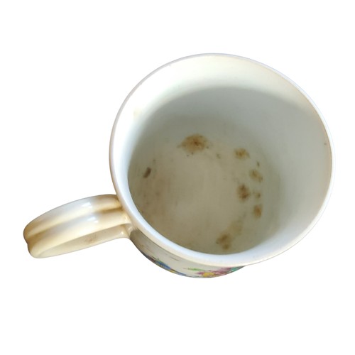 51 - A Bow bell shaped polychrome mug, grooved loop handle and heart-shaped lower terminal, painted with ... 