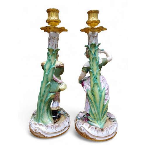 44 - A pair of 19th century figural candlesticks, in the manner of Derby, allegorical of the seasons, Aut... 