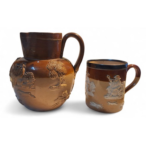 9 - A Doulton Lambeth stoneware mug, applied in white with jolly toper, huntsman and hounds, silver rim,... 