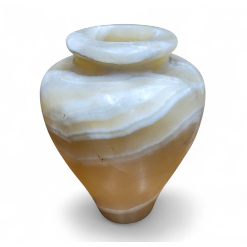 11 - An Egyptian alabaster ovoid vase, 14.5cm high