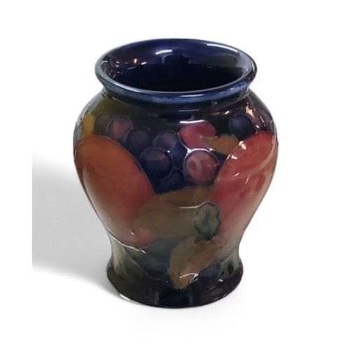 16 - A Moorcroft Pomegranate pattern baluster vase, tube lined with fruit and berries, in tones of red, p... 