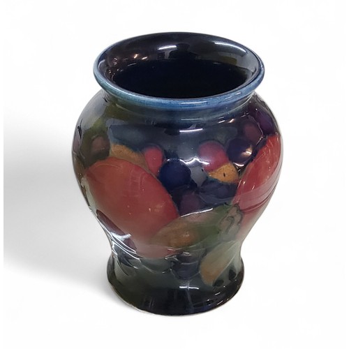 17 - A Moorcroft Pomegranate pattern baluster vase, tube lined with fruit and berries, in tones of red, p... 