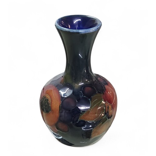 21 - A Moorcroft Pomegranate pattern bottle vase, flared neck,&nbsp; tube lined with fruit and berries, i... 