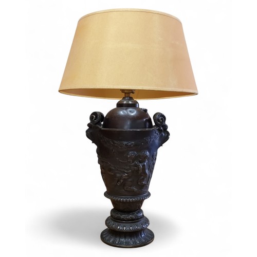 163 - An early 20th century Neo-classical style bronze lamp base, cast with frolicking cherubs and laurel ... 