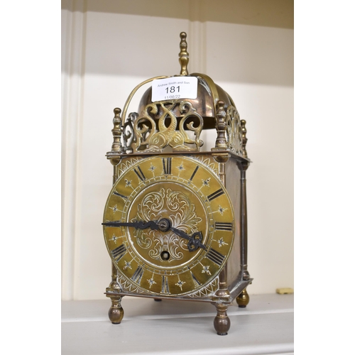 181 - A reproduction brass lantern clock in the 17th century style, 24 cm high