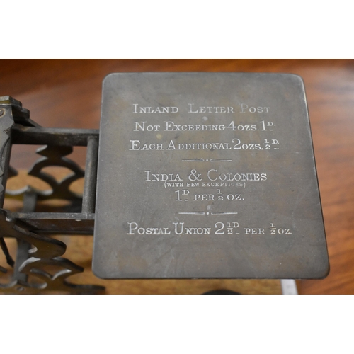 196 - An antique set of brass postage scales on oak base, with weights