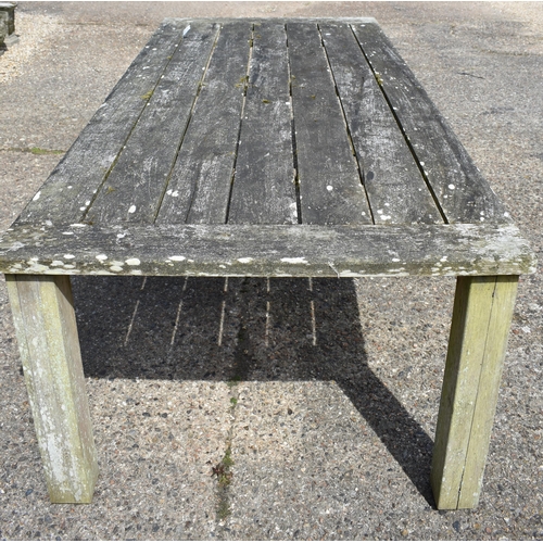 62 - A large weathered teak garden dining table by 'Chic Teak', with cleated rectangular top on square le... 