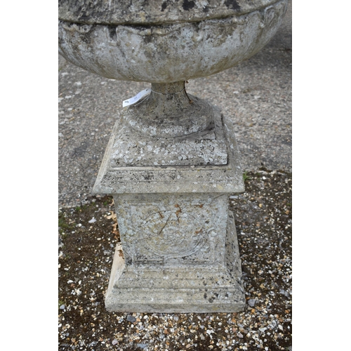 69 - A Regency style weathered reconstituted stone garden urn planter standing on a square pedestal base,... 