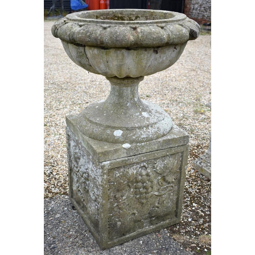 70 - A Regency style weathered reconstituted stone garden urn planter standing on a square pedestal base