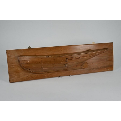 179 - A Victorian carved wood half-hull model of a clinker-built yacht, 64 cm, mounted on a later plaque