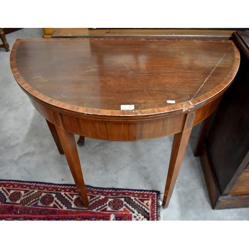 499 - A 19th century mahogany crossbanded demi-lune card table with baize lined folding top and square tap... 