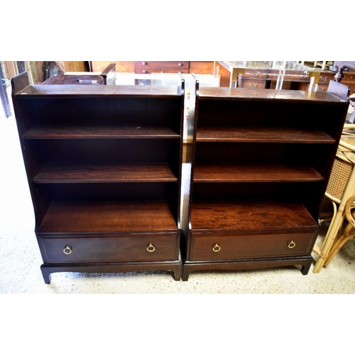 508 - A pair of 'Stag' brand waterfall bookcases, with drawer to base raised on shaped bracket feet, each ... 