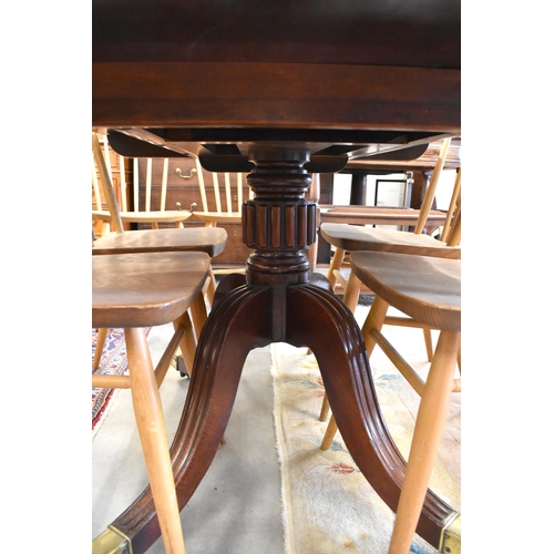 522 - A Victorian mahogany tilt top dining table with brass casters, 121 x 93 x 71 cm