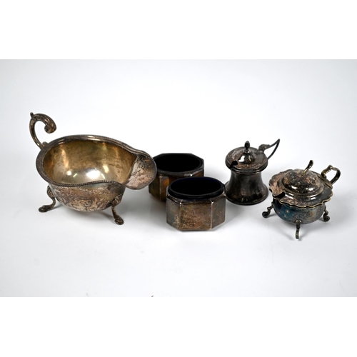 22A - A silver sauce-boat with scroll handle and three hoof feet, Birmingham 1931, to/w a pair of Art Deco... 