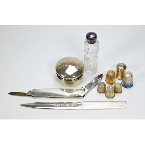 26 - Five silver thimbles and an unmarked example, to/w a letter-knife, silver-handled penknife, pill box... 