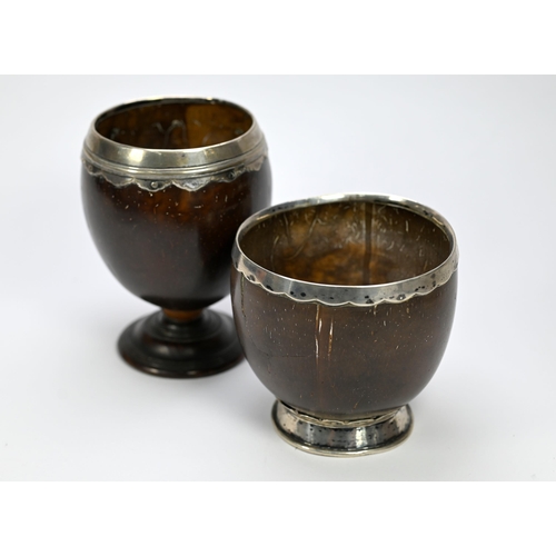 28 - Two antique coconut cups with white metal rims, one with moulded foot-rim, 12cm high, the other with... 