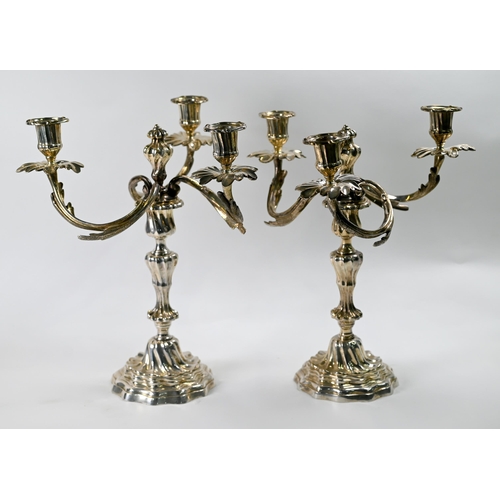 5 - A pair of Continental electroplated three-branch candelabra with detachable tops and baluster stems.... 