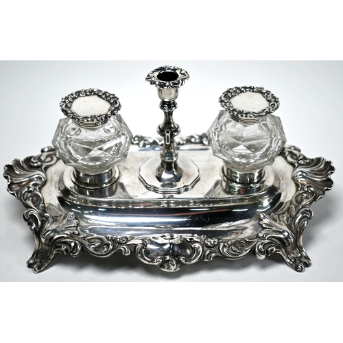 51 - A Victorian Rococo Revival silver inkstand with detachable taperstick enclosing knib-well, flanked b... 