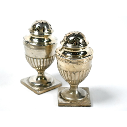 60 - A pair of Adam Revival silver casters of half-reeded urn form, on stemmed square bases, Charles Stua... 