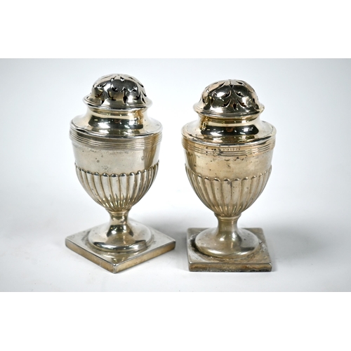 60 - A pair of Adam Revival silver casters of half-reeded urn form, on stemmed square bases, Charles Stua... 