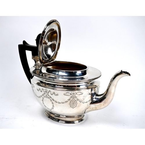 61 - An Edwardian Adam Revival silver three-piece tea service engraved with ribbons and garlands, James D... 