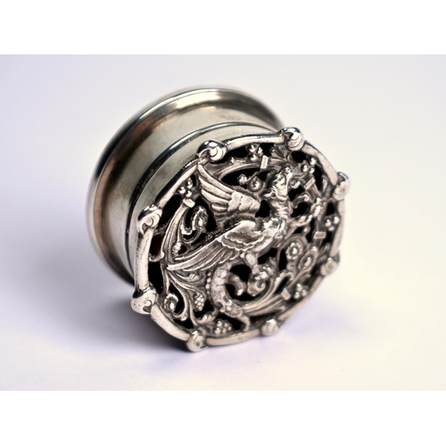 62 - A small cylindrical silver pomander, the pierced cover cast with a gryphon, London 1910, 3.5cm diame... 