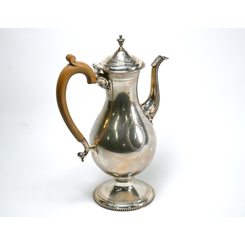 73 - A silver coffee pot in the Georgian manner, of baluster form with engraved and beaded decoration and... 