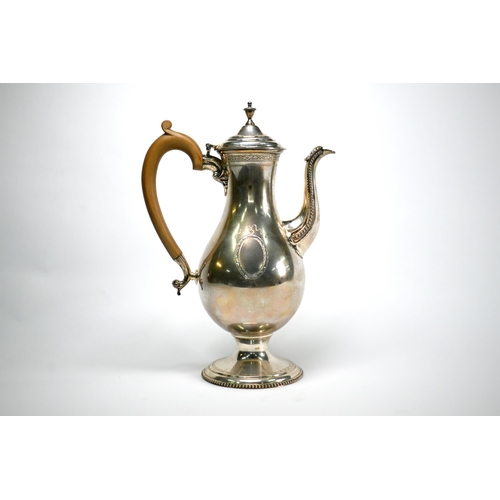 73 - A silver coffee pot in the Georgian manner, of baluster form with engraved and beaded decoration and... 