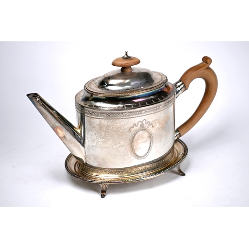 74 - An oval silver teapot in the Georgian manner with beaded rims and engraved decoration, C.J. Vander L... 