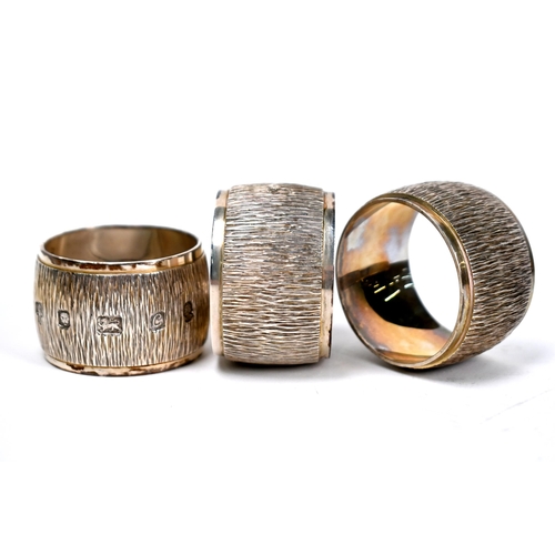 76 - A set of ten heavy quality silver napkin rings with textured decoration,  C.J. Vander Ltd, London Ju... 