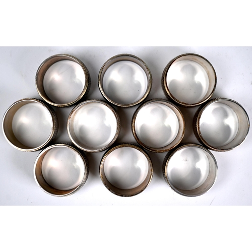 76 - A set of ten heavy quality silver napkin rings with textured decoration,  C.J. Vander Ltd, London Ju... 