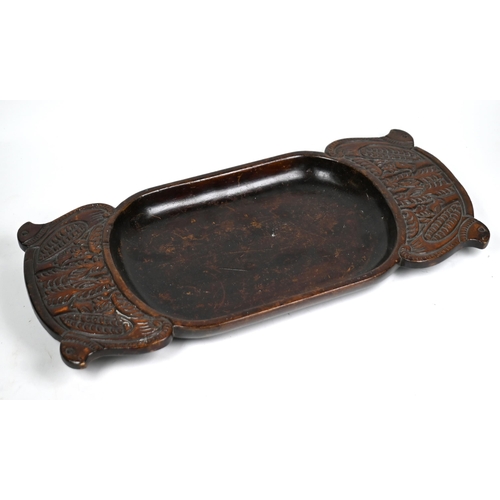 1237 - A Polynesian carved wood ceremonial dish, the broad handles worked with stylised birds, 43 x 19 cm