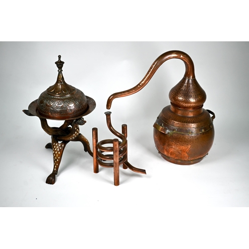 1239 - A Middle Eastern hammered copper alembic (rosewater still) with companion distillation coil, 35 cm h... 