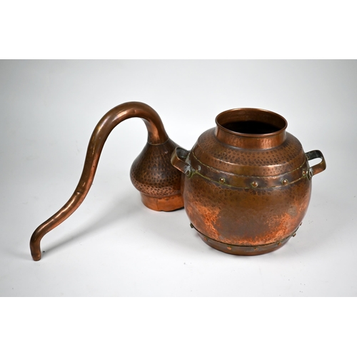 1239 - A Middle Eastern hammered copper alembic (rosewater still) with companion distillation coil, 35 cm h... 