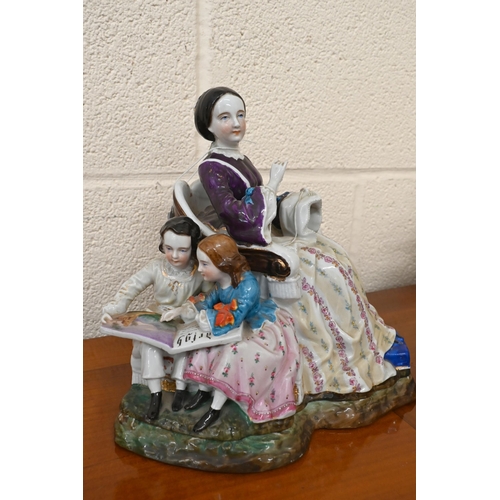 101 - A late 19th century Continental porcelain group of a domestic scene with mother sewing, her children... 