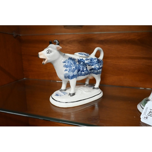 148 - Two early 19th century pearlware Willow pattern cow creamers, to/w a Staffordshire cow and milkmaid ... 