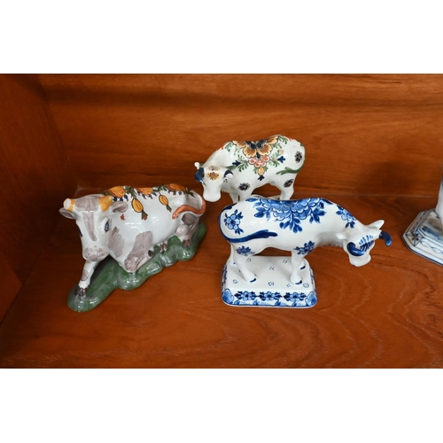 148 - Two early 19th century pearlware Willow pattern cow creamers, to/w a Staffordshire cow and milkmaid ... 