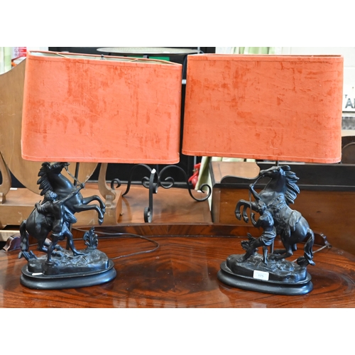 175 - A pair of bronzed spelter Marley horses, mounted on table lamp bases